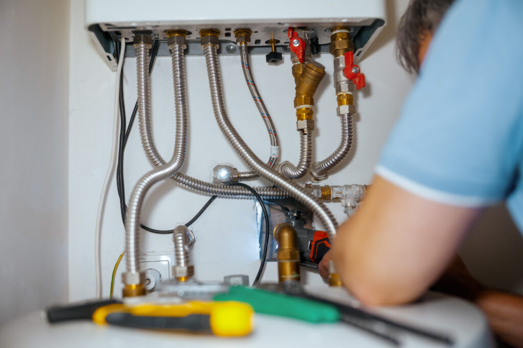Plumber Actively Repairing a Water Heater